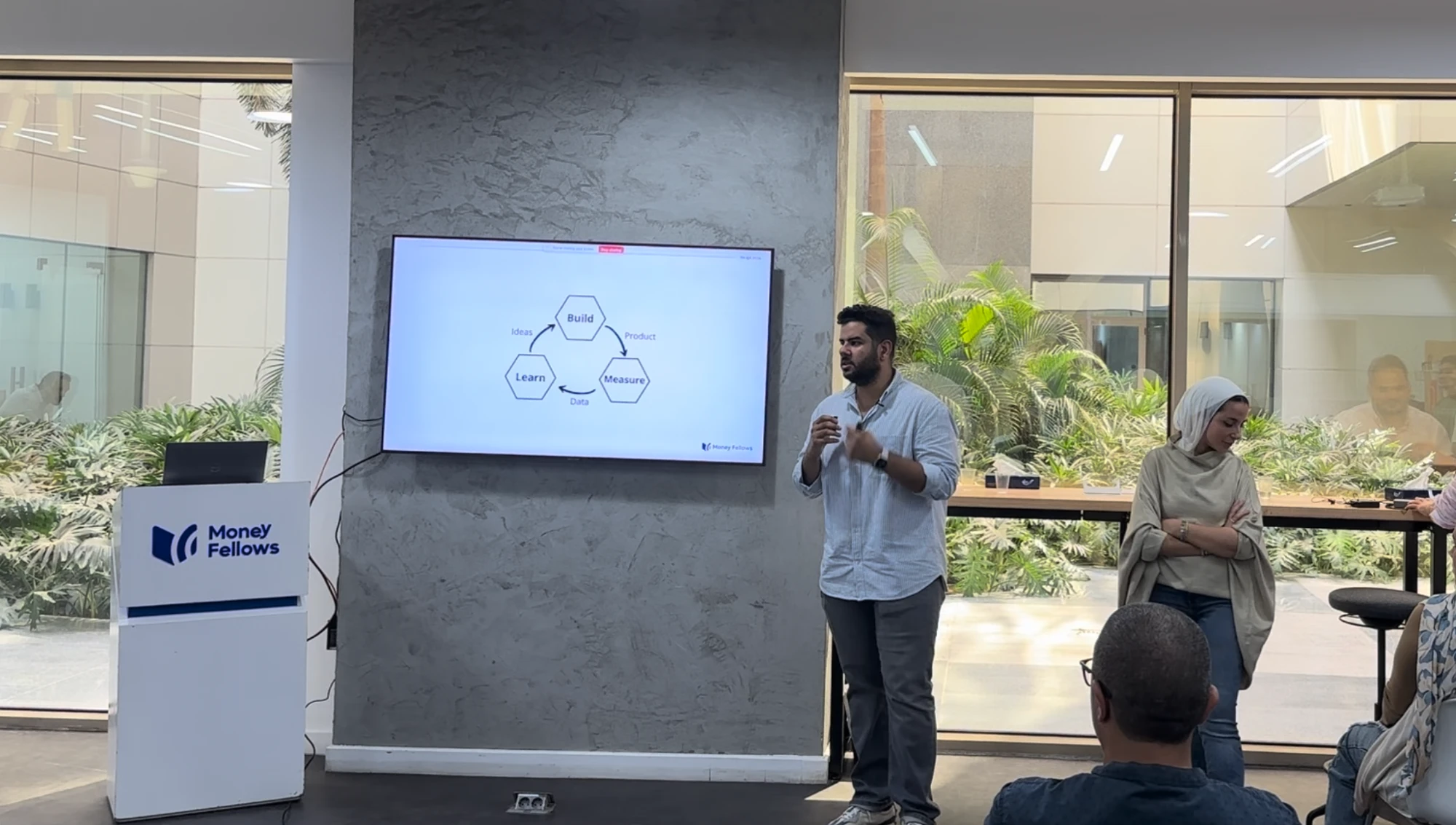 Amir presenting the Build, Measure, Learn loop at Money Fellows