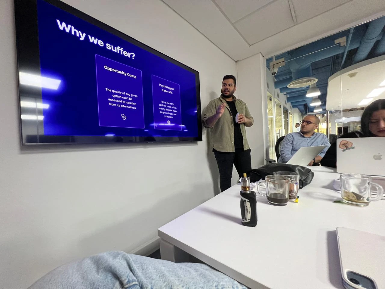 Amir presenting a talk on opportunity costs and the psychology of trade-offs