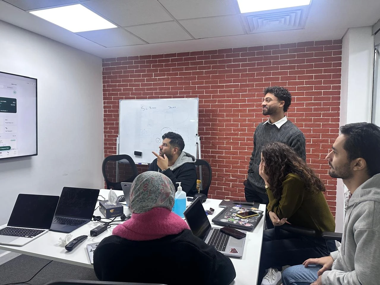 Amir and his design team reviewing a product screen together